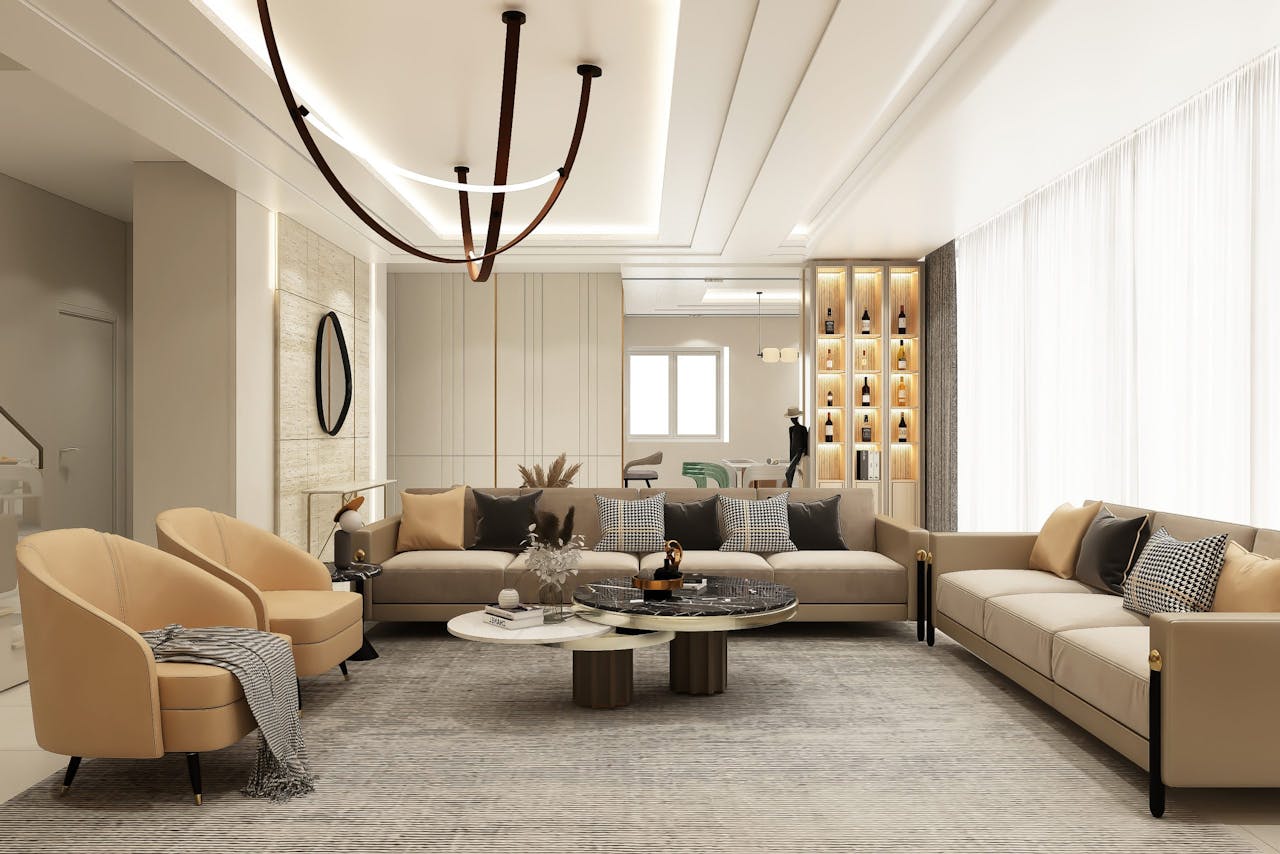 Stylish sitting area featuring beige sofas, elegant lighting, and chic decor.