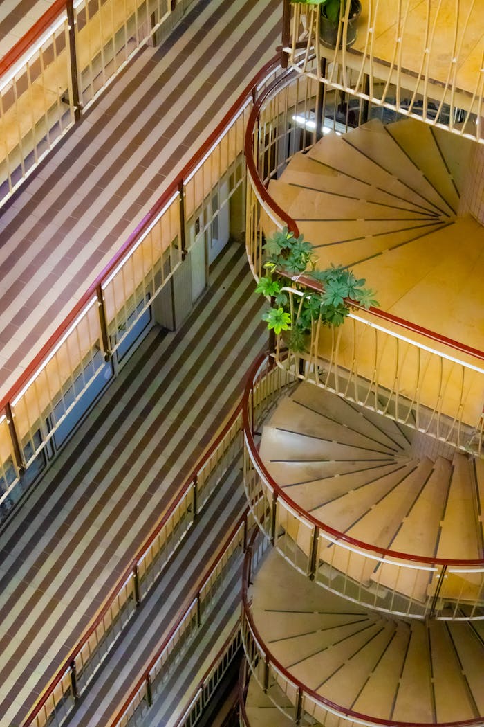 Aerial view of elegant spiral stairs and patterned floors in an Istanbul building.