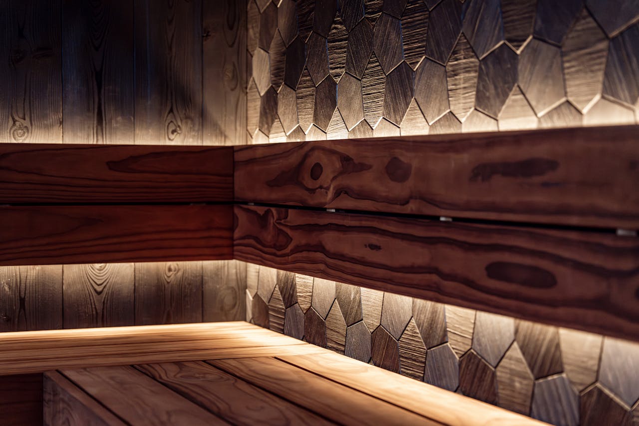 A beautifully crafted indoor sauna showcasing Nordic design with warm LED lighting.